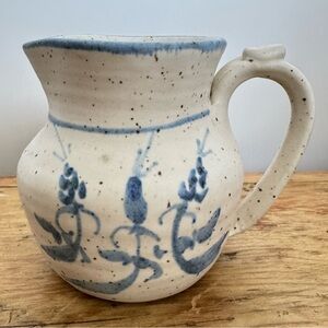 Stoneware pottery pitcher with blue floral decoration and salt glaze finish